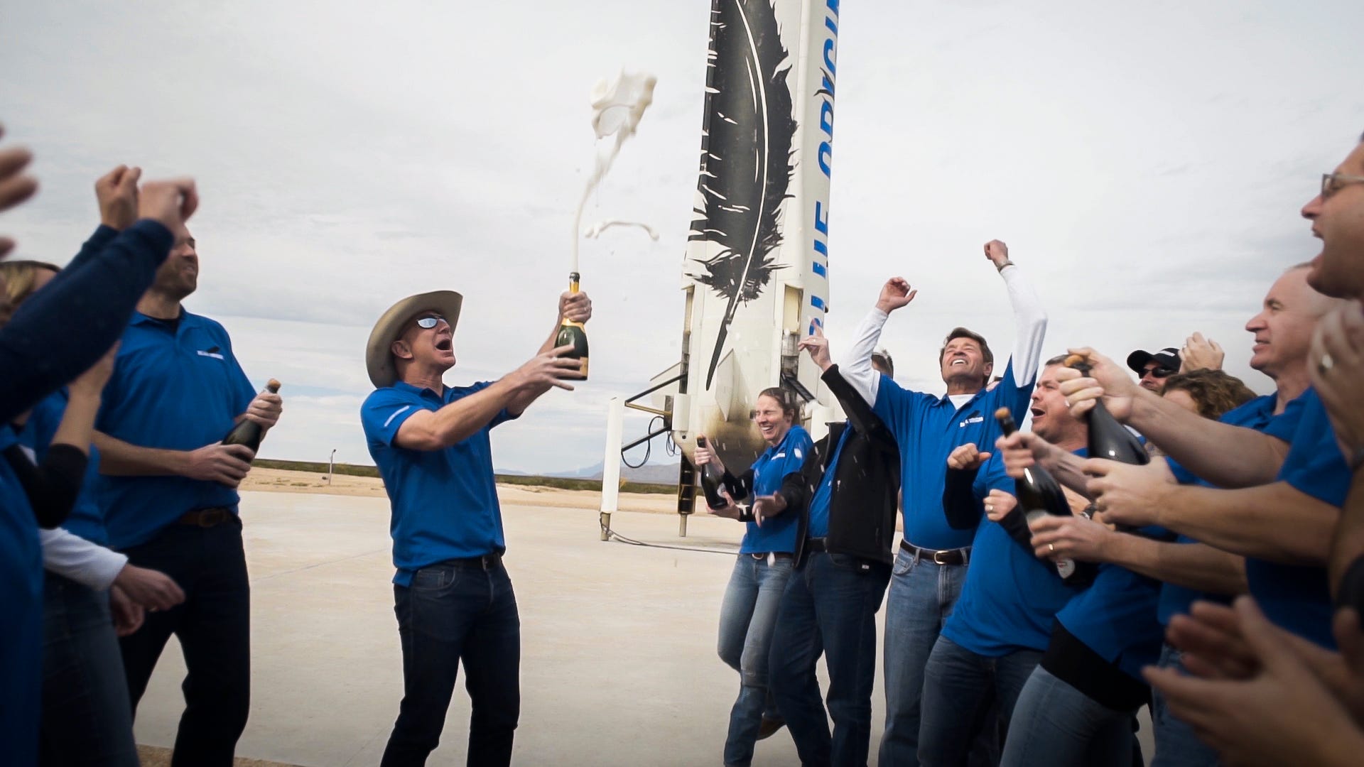 jeff bezos popping champagne with blue origin employees new shepard rocket