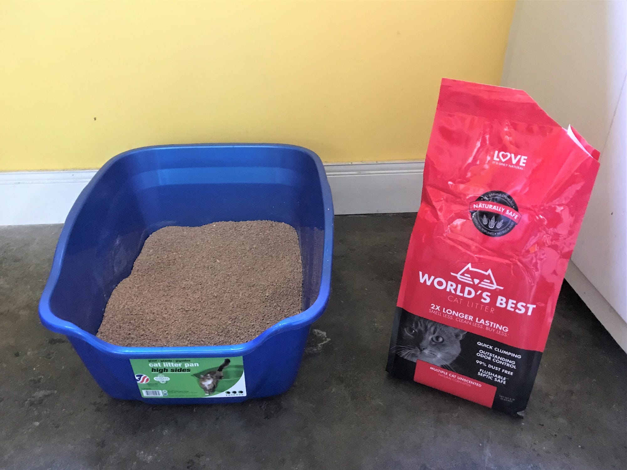 a litter box filled with worlds best multiple cat litter and the bag beside it