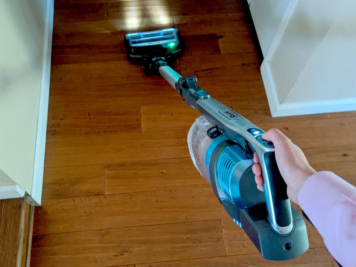 image of a hand holding the shark vertex cordless vacuum, our pick for the best cordless vacuum overall in 2021