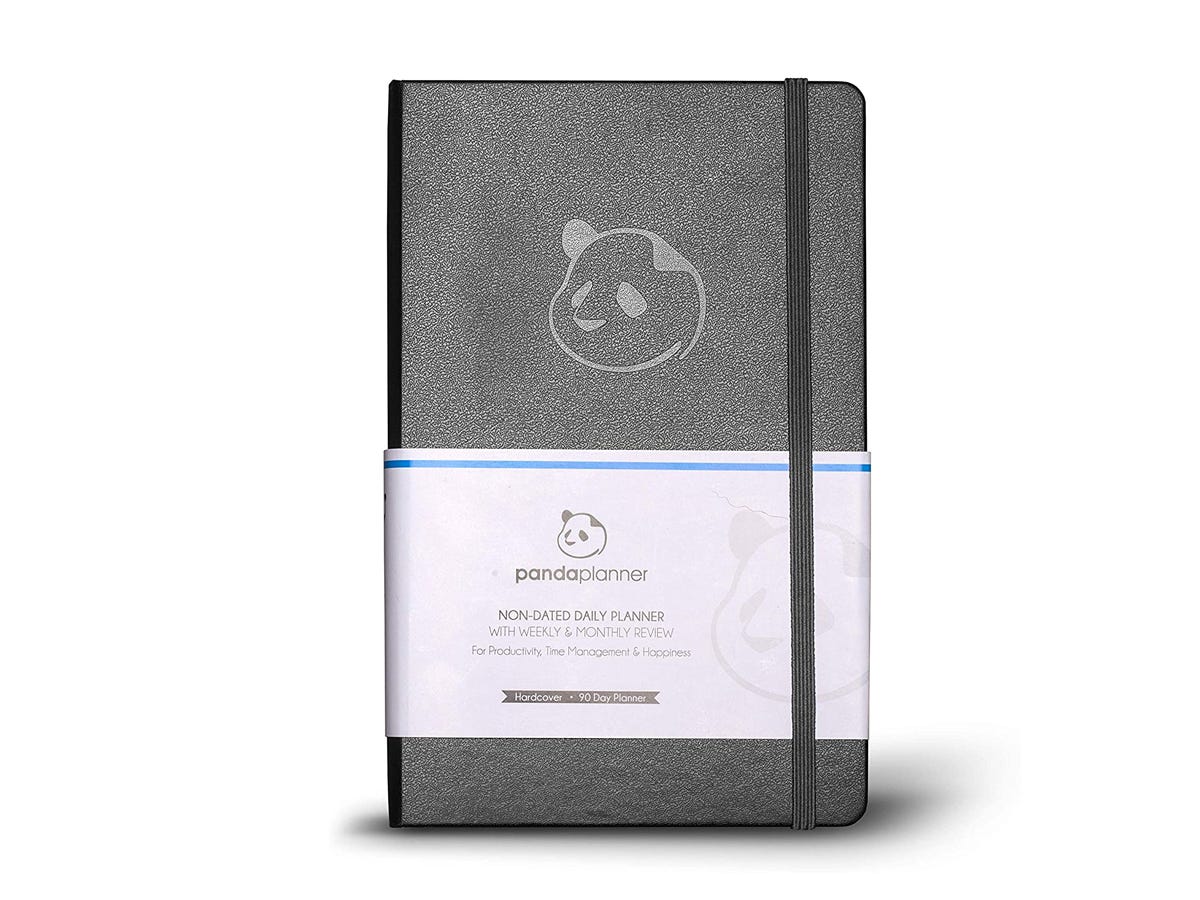 A black and grey daily planner with the Panda Planner logo and an elastic strap