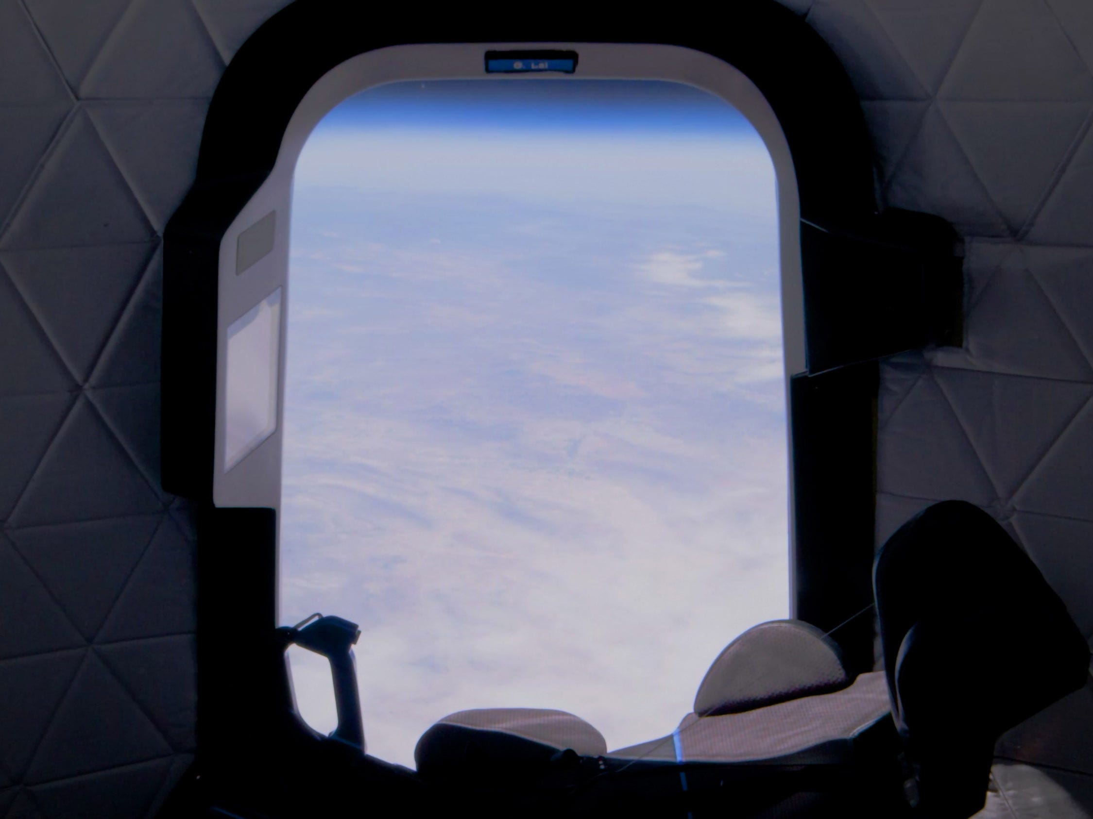 blue origin new shepard crew capsule view from spaceship window in space