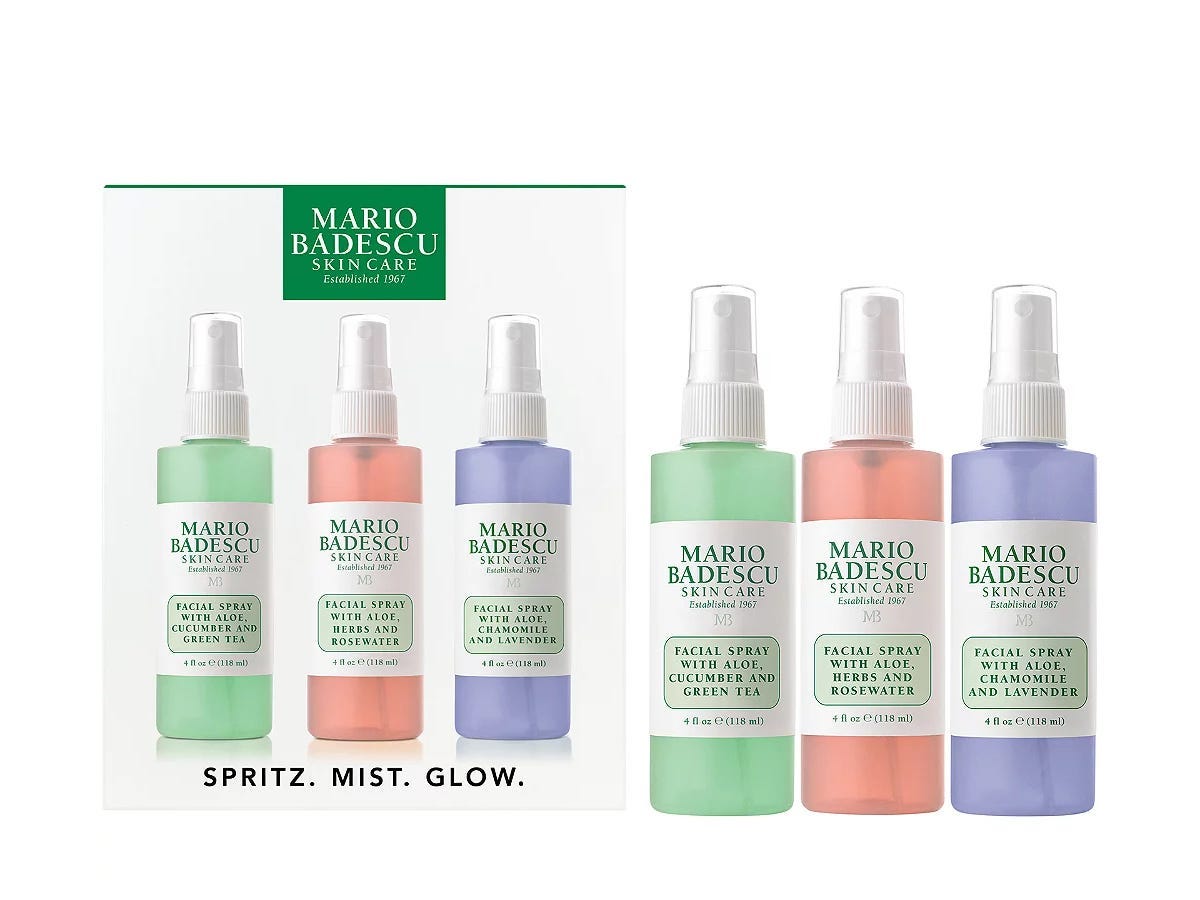 Three bottles of face mists from Mario Badescu; one is green, one is pink, and one is purple.