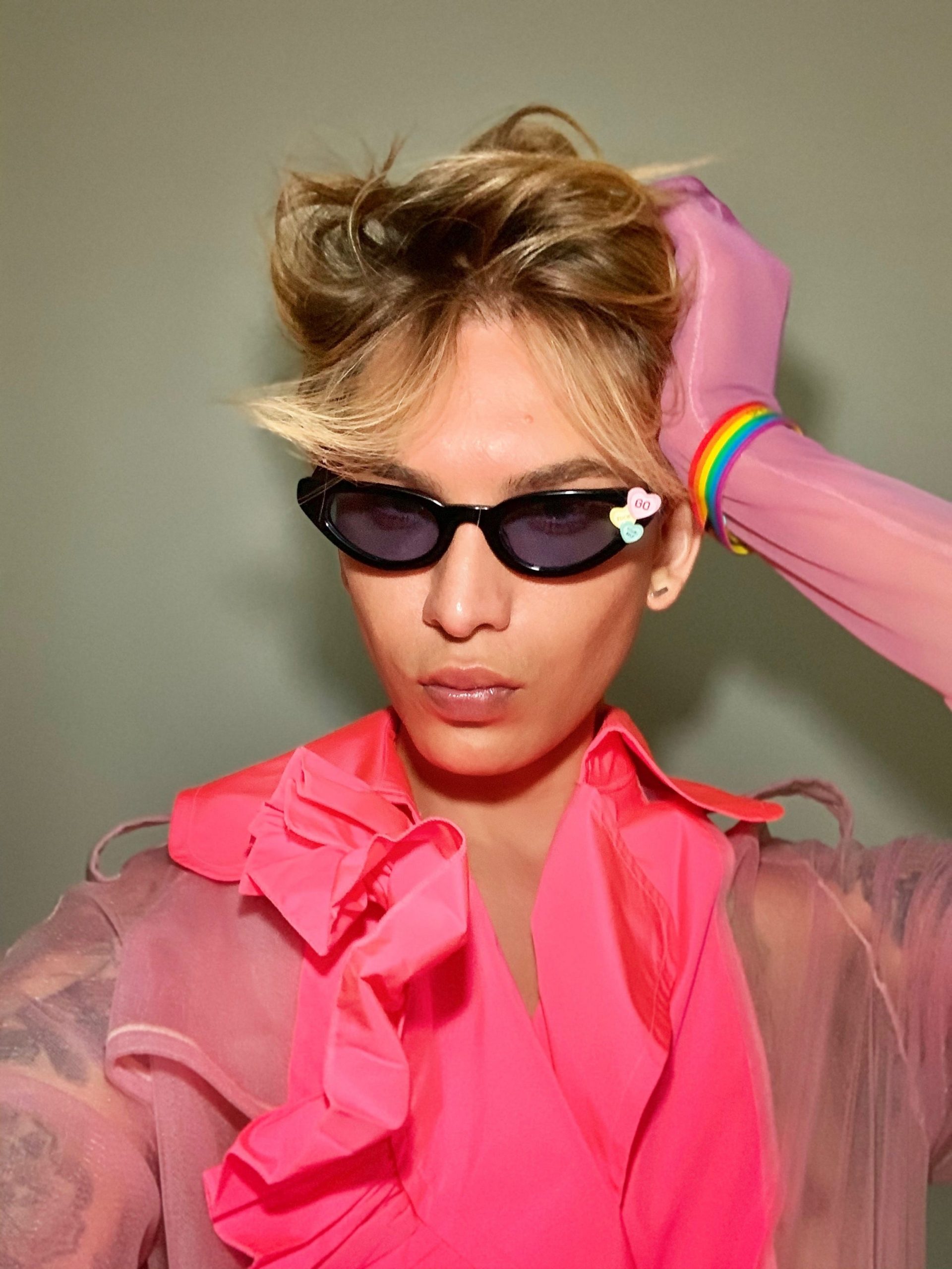 Miss Fame poses in sunglasses and a pink outfit