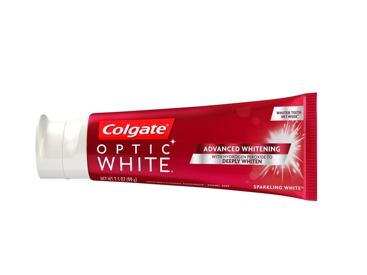 A tube of Colgate Optic White Advanced Sparkling White toothpaste on a white background