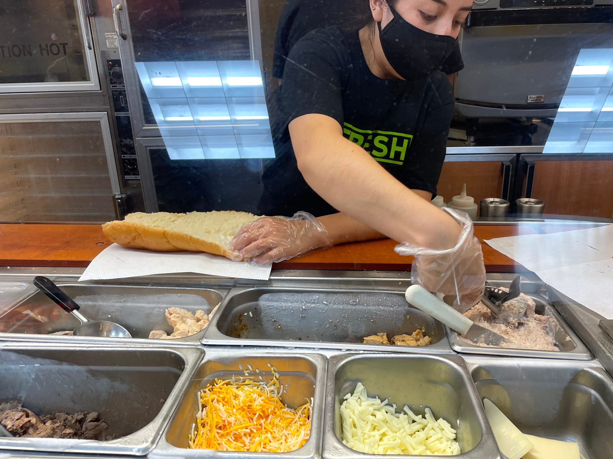 Subway worker making tuna sandwich