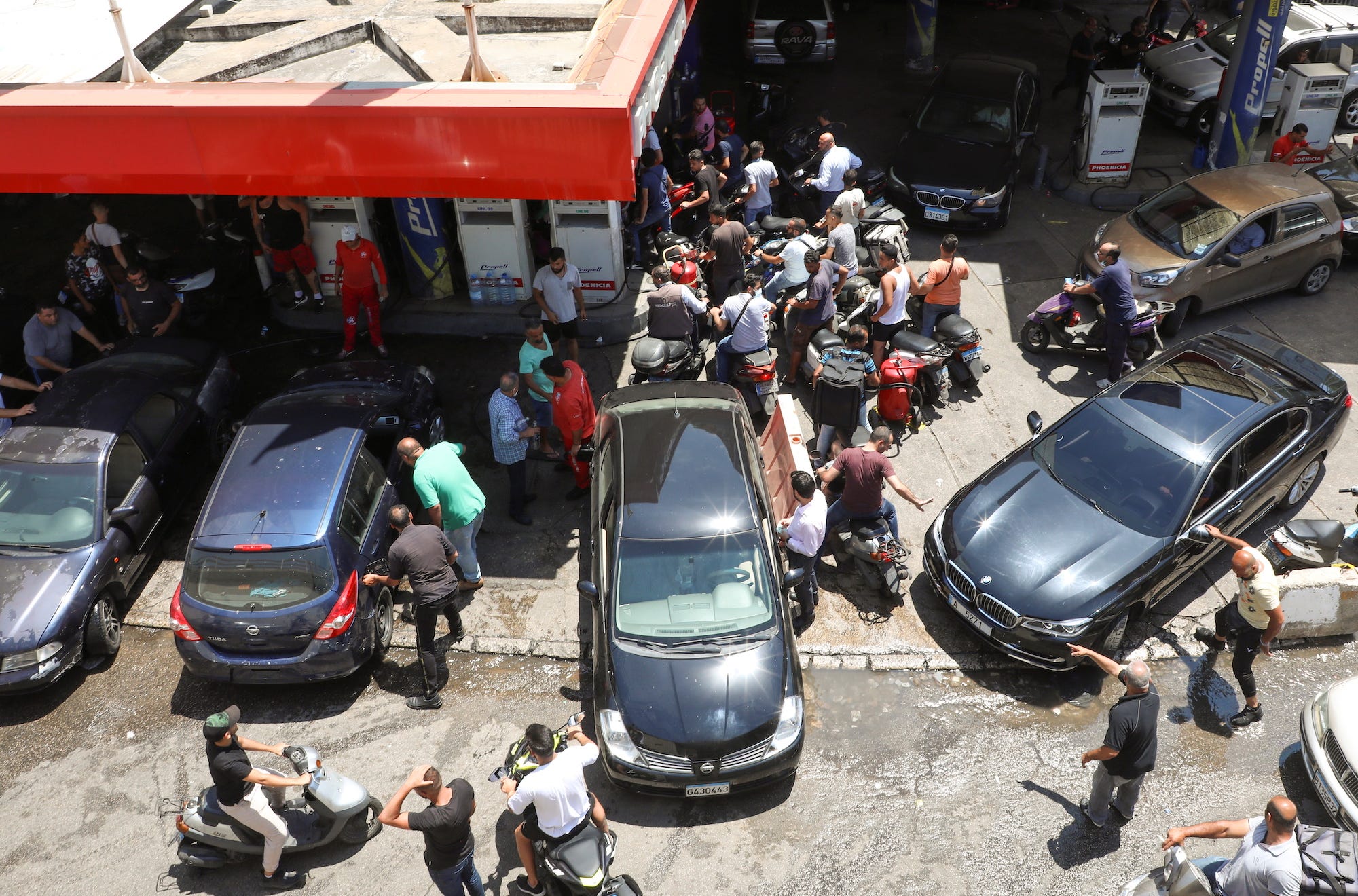 Cars and motorbikes wait for fuel in Beirut